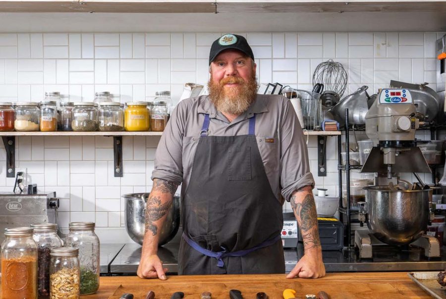Man standing in his kitchen.